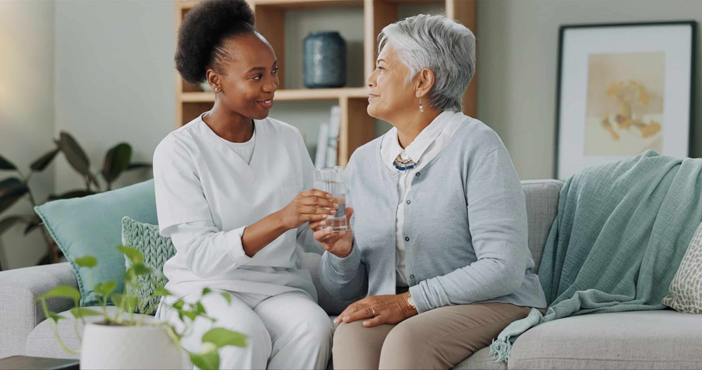 Elderly woman receiving compassionate care from a caregiver at home.