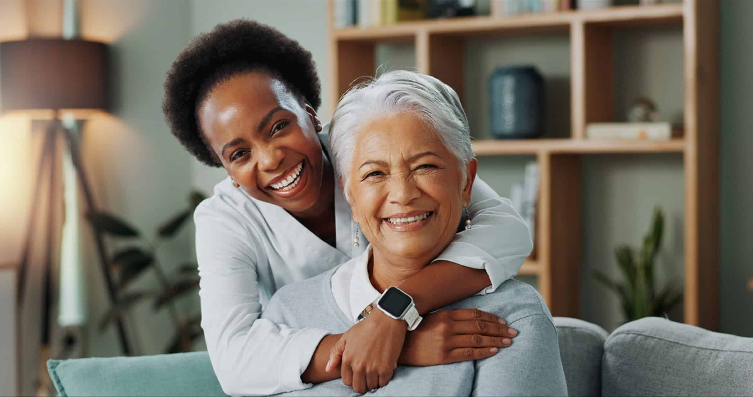 Compassionate caregiver with elderly woman at home.