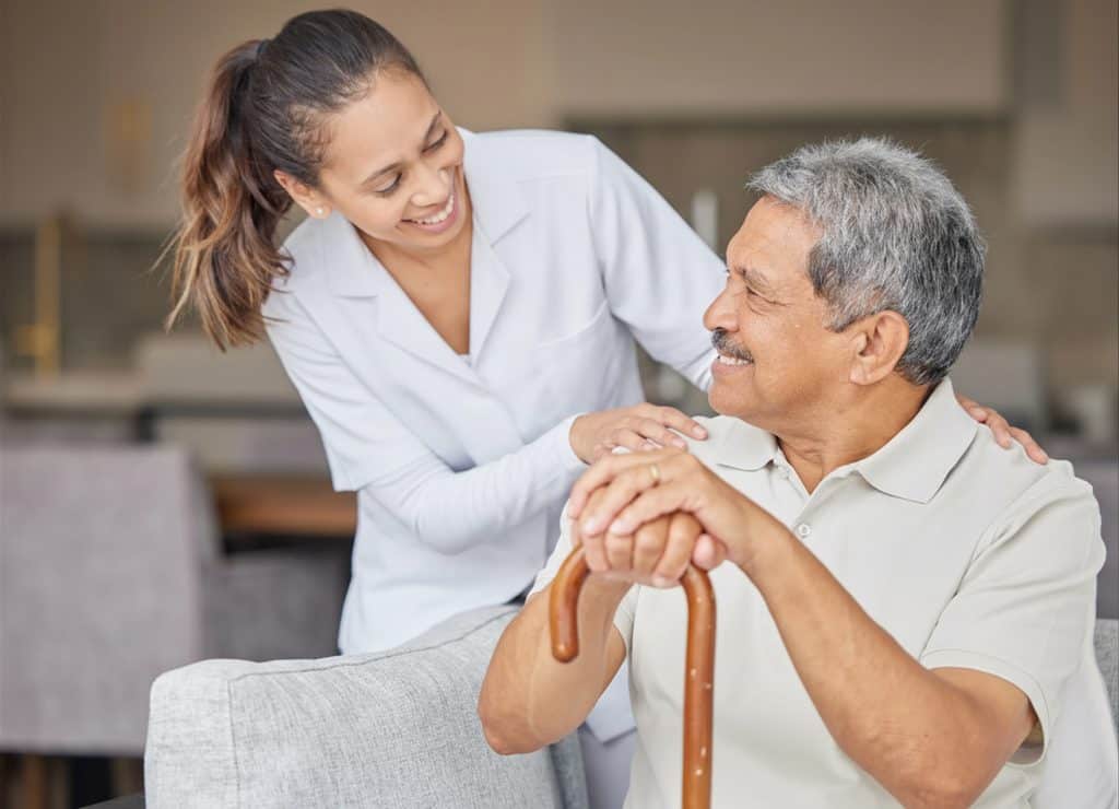 Elderly man receiving compassionate care from a caregiver at Serenity Care facility.