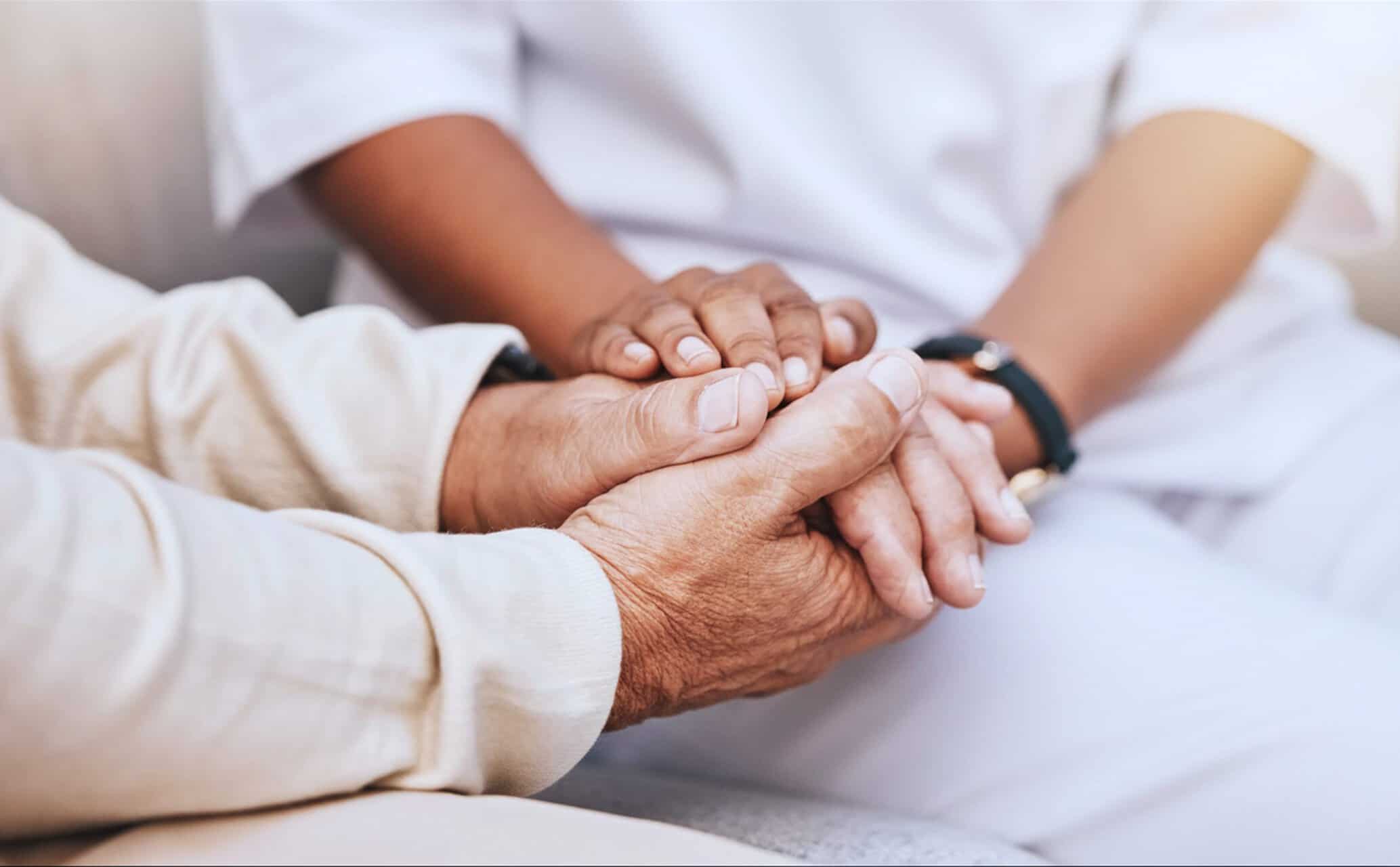 Two hands holding each other gently